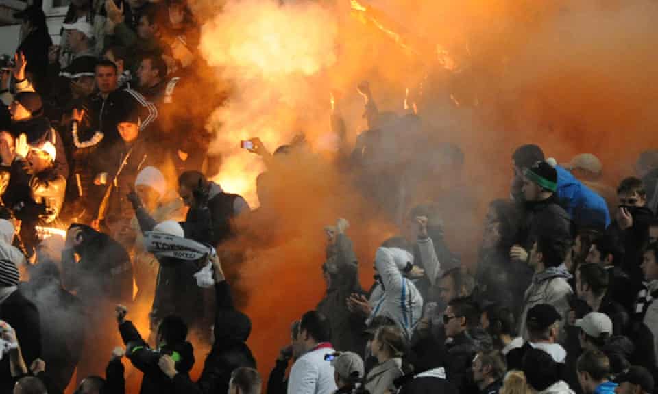 Russian soccer fans light flares during a fourth round Russia Cup match between Dinamo Moscow and Torpedo Moscow, 2012. 