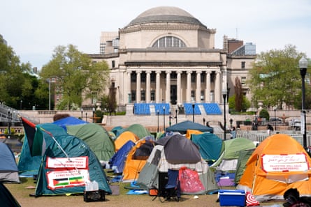 Tents in front of a neo-classical faculty building.
