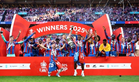 Crystal Palace’s Joel Ward and Marc Guéhi lift the FA Cup and celebrate with teammates and Oliver Glasner