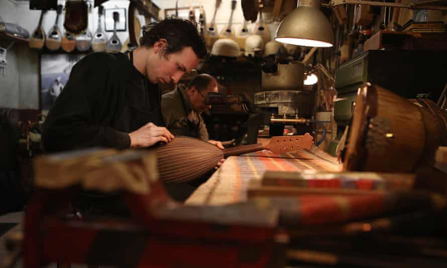 Workman fixing a mandolin at La Bottega Del Mandolino, Naples, Italy.