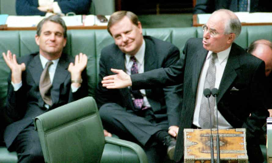 John Howard addresses parliament, watched on by Peter Costello and John Anderson.
