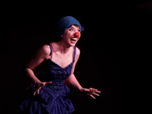 Elizabeth Davie in a blue dress and hat with a red plastic nose