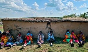 Cultural performers from the Maasai tribe, wearing cloth masks, in Talek in the Maasai Mara national reserve where their work of performing for visiting tourists has dwindled.