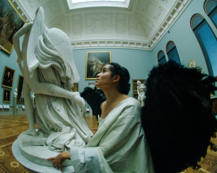 A woman looking at a statue in the museum in a still from the film