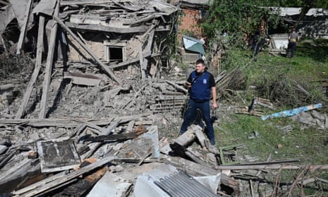 A war crime investigator inspects a destroyed house after the explosion of a guided aerial bomb in Kharkiv, on May 3, 2024, amid the Russin invasion in Ukraine.