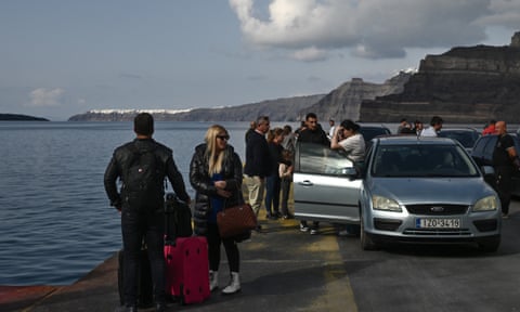 Motorists and travellers wait on the quayside for the arrival of the ferry dqxikeidqkikdinv
