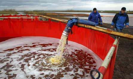 Employees of Russia’s state-owned oil pipeline monopoly Transneft take part in a clean-up operation.