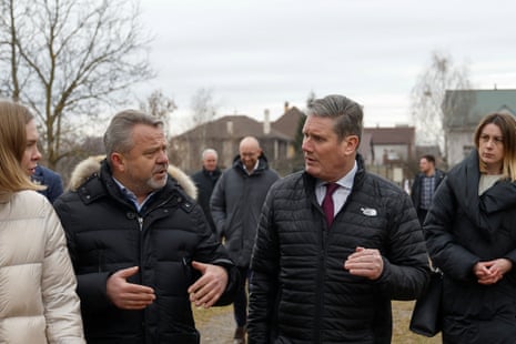 Starmer speaks with the mayor of Bucha, Anatoliy Fedoruk, as he visits the site of a mass grave.
