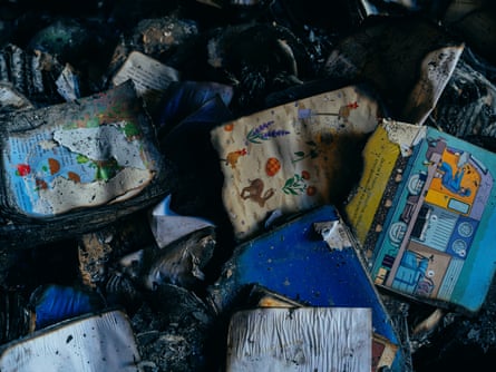 Charred and soggy remains of children's picturebooks illustrated with animals and flowers