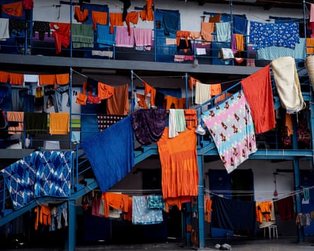 Lots of clothing, much of it orange, hung out to dry on lines