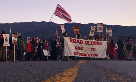 Demonstrators block a road at the base of Hawaii’s tallest mountain, on 15 July.