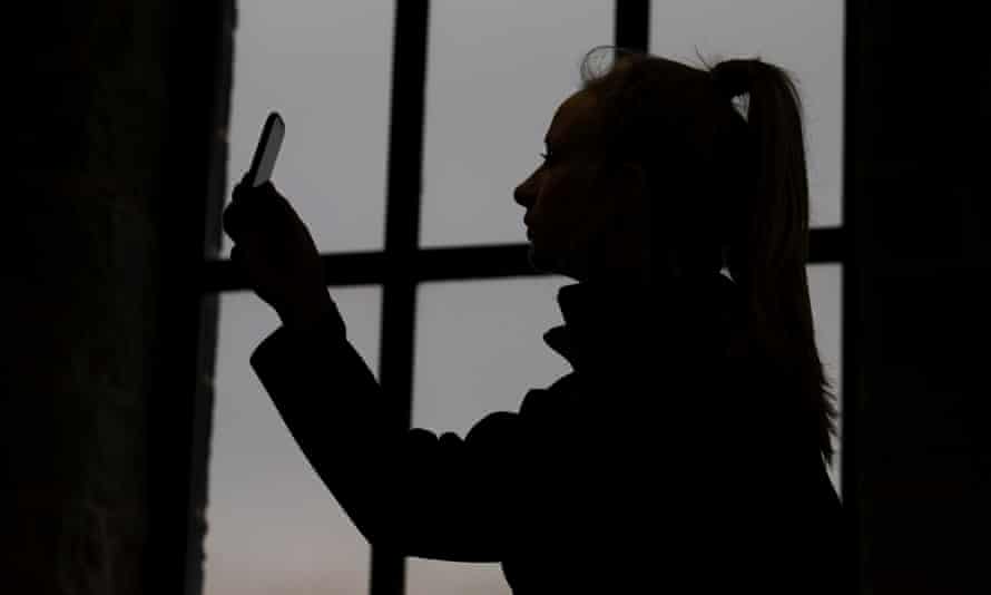 A teenager at Victoria Mill college in Burnley hoding a mobile phone after being taught about the pitfalls of sexting.