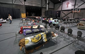 People seeking shelter from below freezing temperatures rest inside a church warming center Tuesday, Feb. 16, 2021, in Houston.