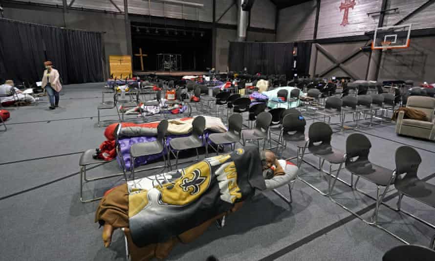 People seek shelter from below freezing temperatures inside a church warming center in Houston.