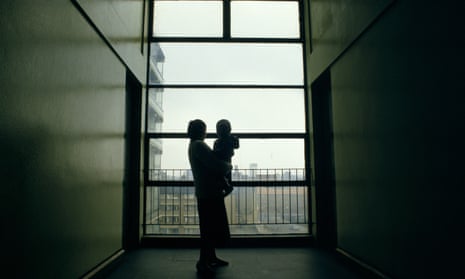 The silhouette of a 17 year old homeless girl with her baby in a corridor in a London building.