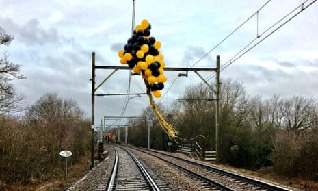 Helium-filled balloons tangled around high-voltage overhead railway wires near Southend