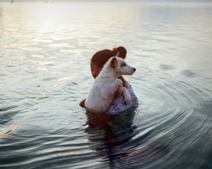 Aurel shares a tender moment with her dog as they bathe in the Indian Ocean off Rote Island in Indonesia