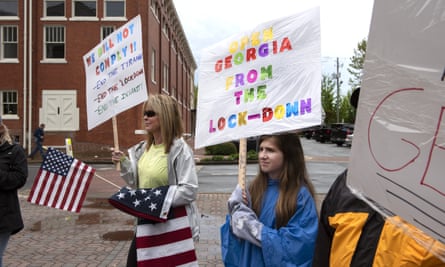 People protest stay-at-home orders outside the Cherokee county courthouse in Canton, Georgia, on 19 April.