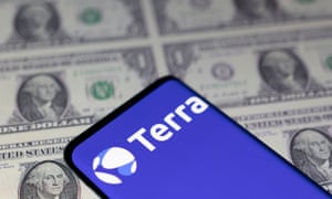 Smartphone with Terra logo is placed on displayed U.S. dollars.