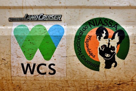 Logos of the Wildlife Conservation Society and Niassa reserve on a Toyota Land Cruiser.