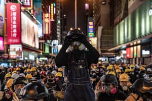 Hong Kong, China
A protester uses binoculars during a stand-off with police. Pro-democracy protesters have continued rallies on the streets of Hong Kong against a controversial extradition bill since 9 June as the city plunged into crisis after waves of demonstrations and several violent clashes