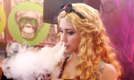 A woman vapes through her nose at the 2017 Vapexpo exhibition. The proposition passed despite its opponents far outspending groups that support the ban.