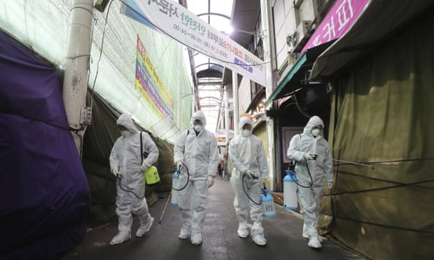 Workers spray disinfectant at a market in Daegu, South Korea on Sunday.