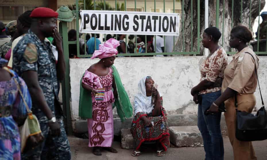 Gambians wait to cast their vote at a polling station in Banjul on Thursday