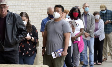 Wearing face masks to prevent the spread of COVID-19, voters line up to cast their ballot during early voting Tuesday, April 27, 2021, in Mansfield, Texas. (AP Photo/LM Otero)