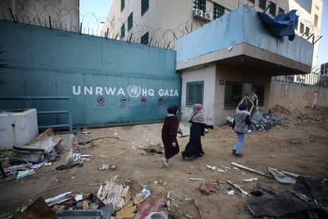 People walk in front of Unrwa headquarters in Gaza