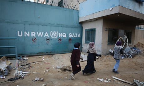 People walk in front of Unrwa headquarters in Gaza