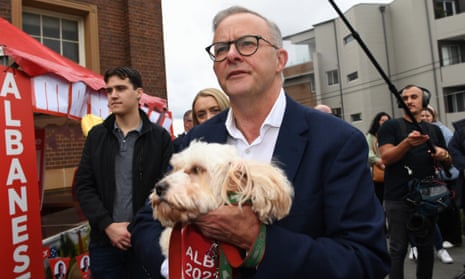 Anthony Albanese carries his dog 'Toto' after casting his vote at a polling booth at Marrickville Town Hall