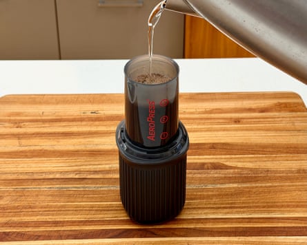 A person making coffee with an aeropress go