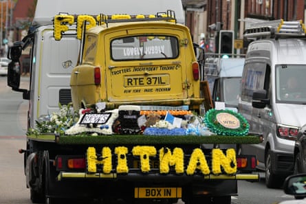 A yellow three-wheeled Reliant Regal leads Ricky Hatton’s funeral cortege.