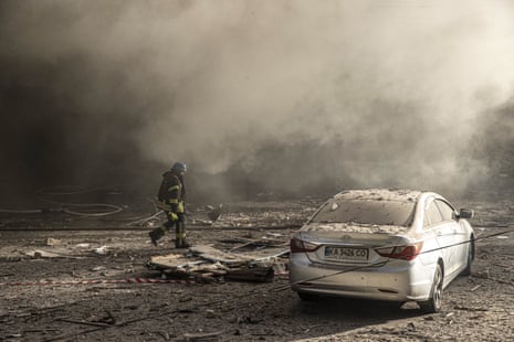 Firefighters conduct work after the Russian drone attacks in Kyiv.