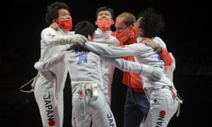 Japan’s Koki Kano, Kazuyasu Minobe, Masaru Yamada and Satoru Uyama celebrate with a team member after winning gold.