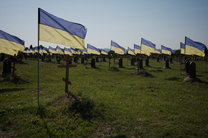 Some wooden crosses have been replaced by round granite stones and are all identical at these unidentified graves in Dnipro.