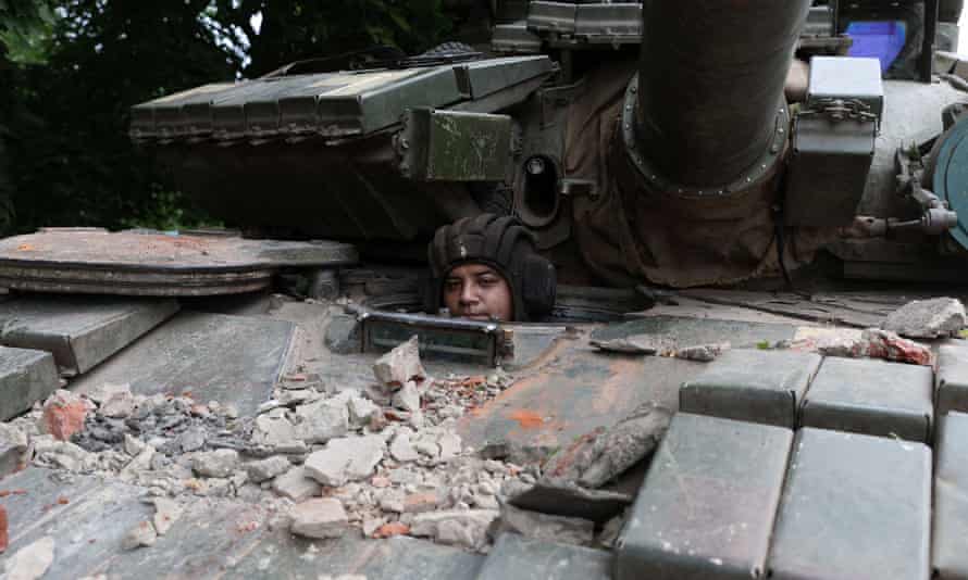 A Ukrainian serviceman peers out from a tank at a front line position near Kostyantynivka, Donetsk region on 18 June, amid the Russian invasion of Ukraine.