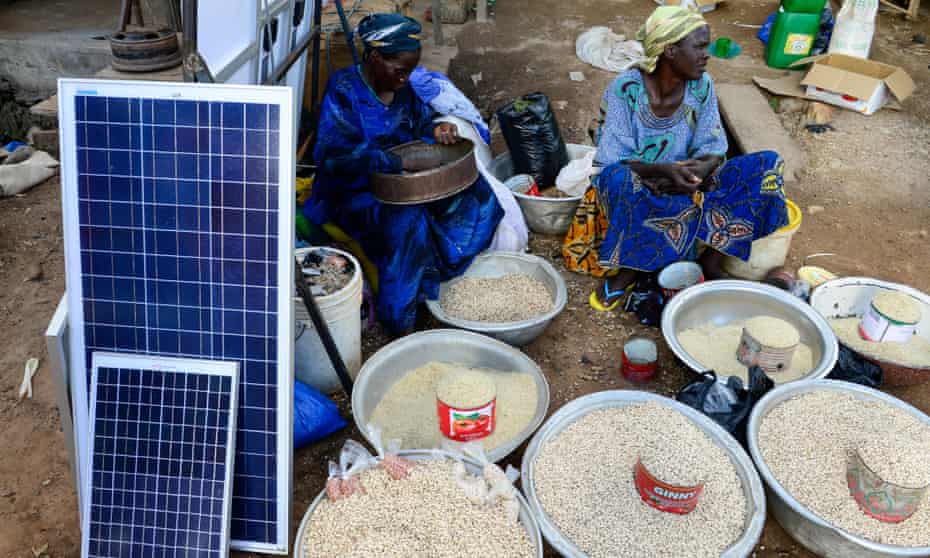 Grain and solar panels for sale at a market in Gaoua, Burkina Faso.