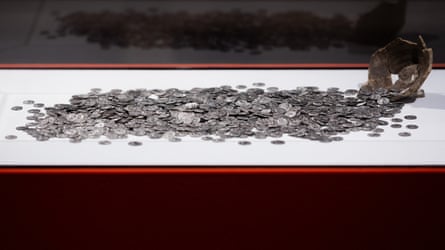 Ancient Roman silver coins displayed in a pile on a white background at the LVR State Museum in Bonn, Germany.