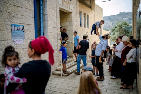 Voters queue outside a polling station in Hebron in the West Bank