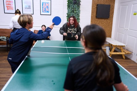 Teenagers play table tennis with a youth worker at a Middlesbrough youth club