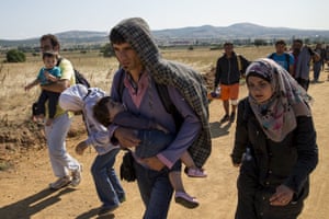 Syrian refugees walk along a road in Miratovac, Serbia