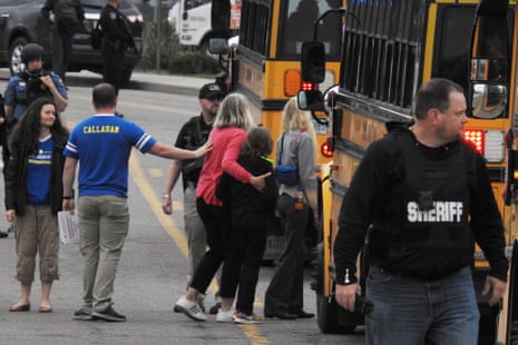 Students escorted school bus in front of STEM School Highlands Ranch after a shooting.