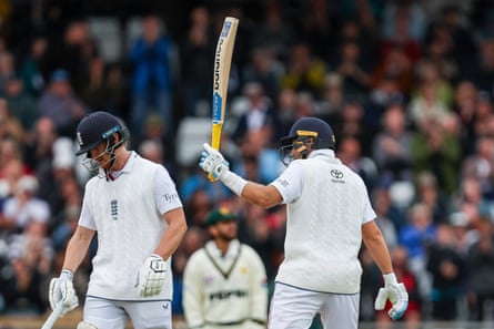 Joe Root raises his bat to celebrate his half century during day two of the first Test between England and Pakistan at Headingley