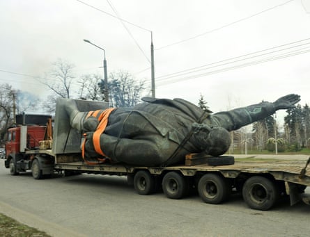 A truck carries a statue of Lenin on a road in Ukraine