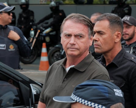 Jair Bolsonaro with security forces around him