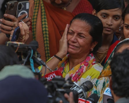 A woman is crying and holds her hand on the side of her face