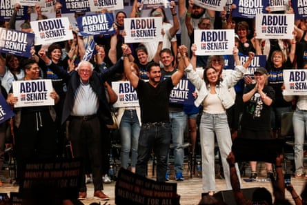 A crowd of people hold up signs that say Abdul El-Sayed.
