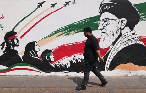 A man walks past a mural of Iran's former supreme leader, Ali Khamenei, along a street in downtown of Tehran on 31 August 2026. Khamenei was killed in joint US-Israeli strikes on the opening day of the war on 28 February.
